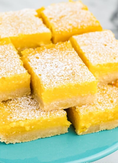 lemon bars on a blue cake plate