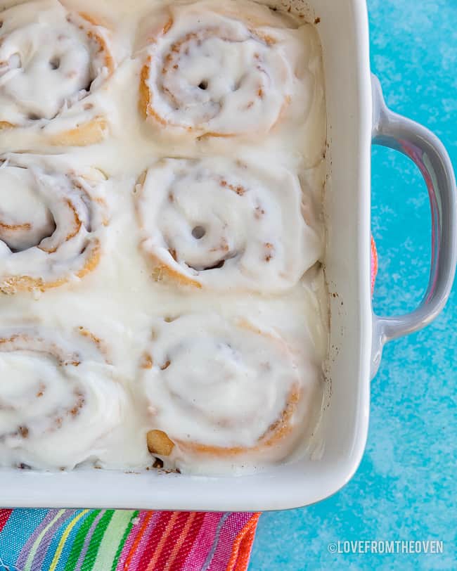 Pan of no yeast cinnamon rolls on a blue background