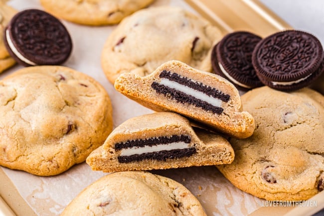 Chocolate chip cookies with oreos inside on a baking sheet