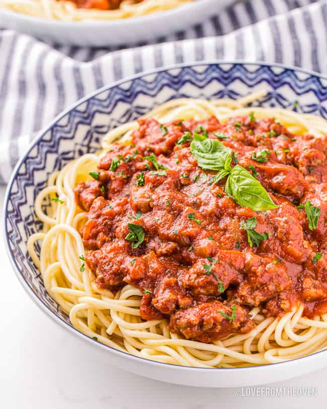 bowl of spaghetti with pasta sauce on top