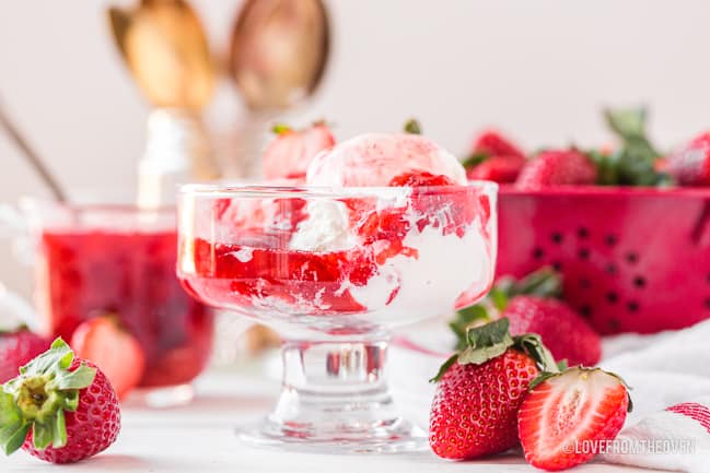 strawberry sauce on ice cream with strawberries