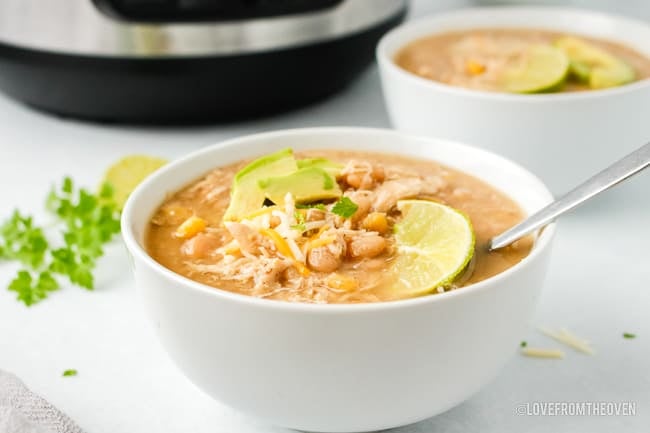 A bowl of chicken chili on a countertop