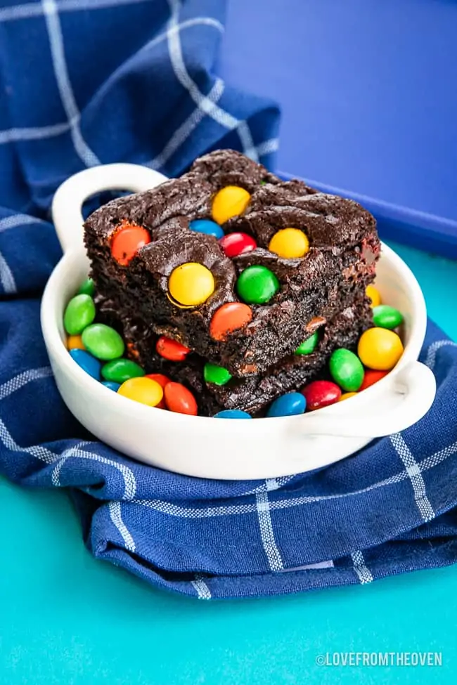 a photo of chocolate brownies with M&Ms on top of them