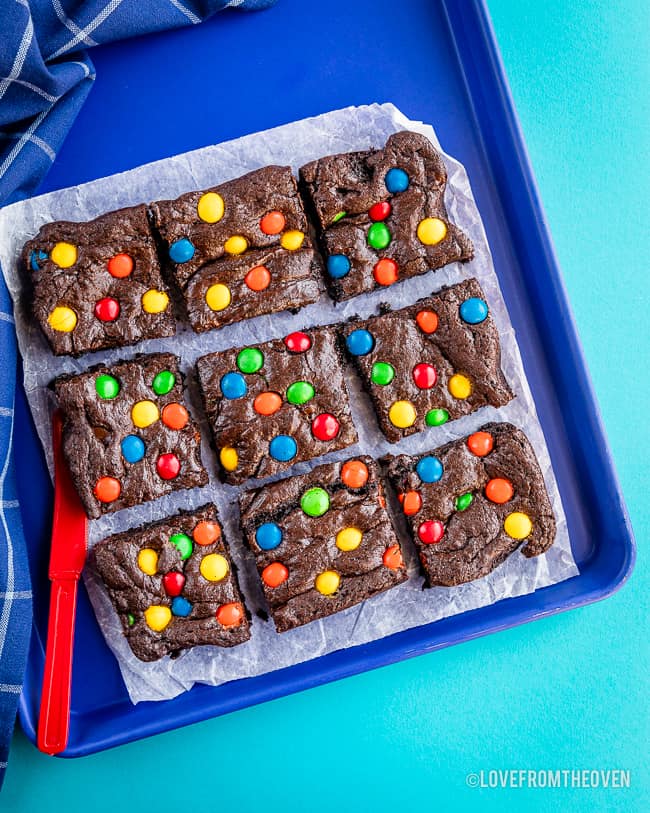 a batch of MM fudge brownies on blue background