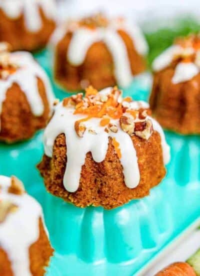 mini carrot cakes on a teal colored pan