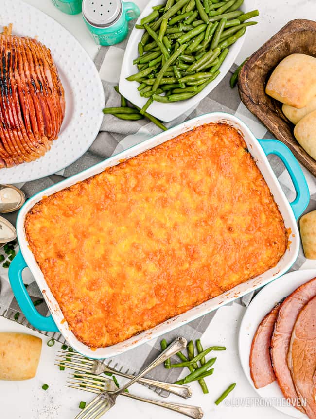 A cheesy casserole on a table with food