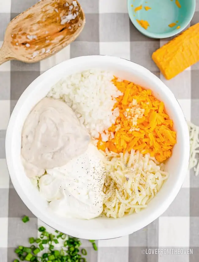 a bowl of ingredients to make cheesy hash browns
