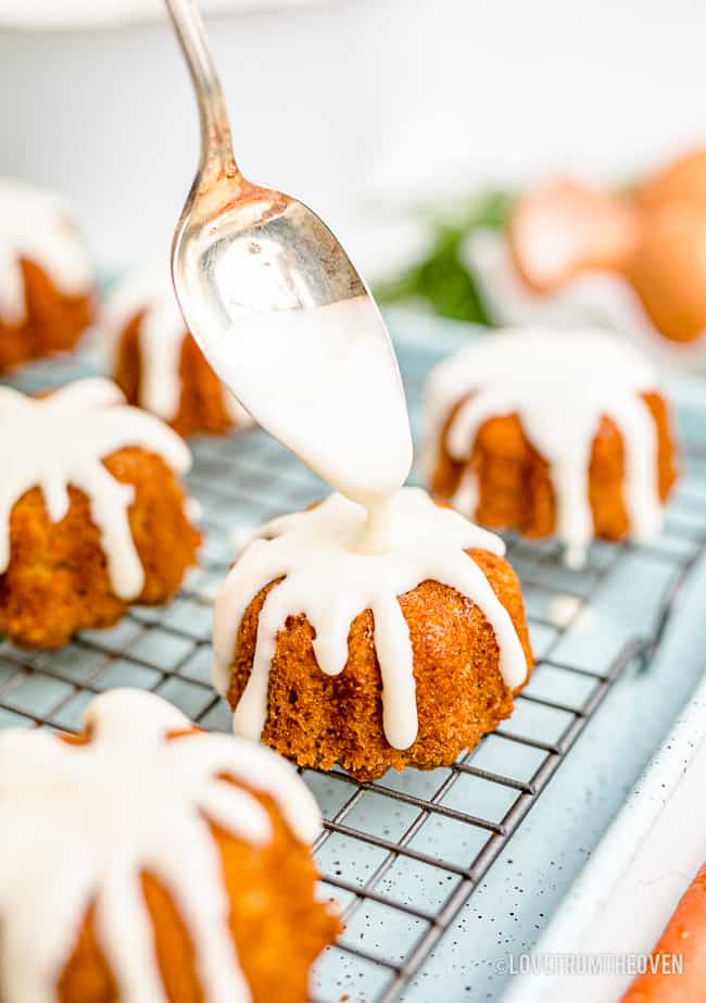 frosting being put on mini bundt cakes