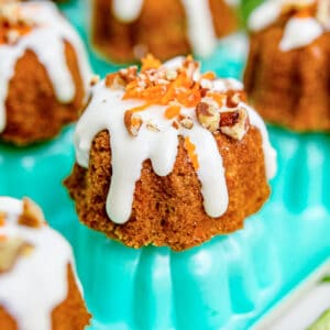 mini carrot cakes on a teal colored pan