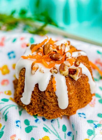 A mini carrot cake on a floral napkin.