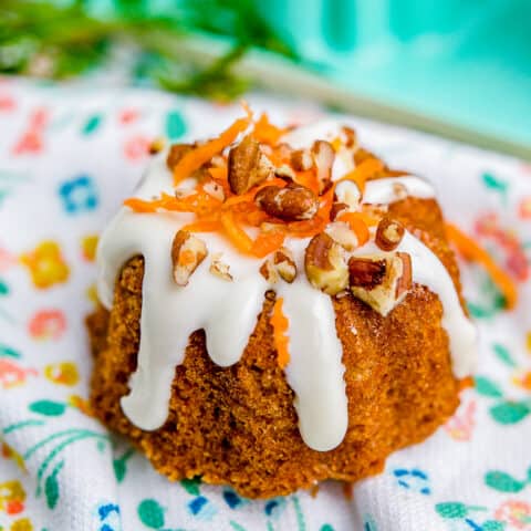 A mini carrot cake on a floral napkin.