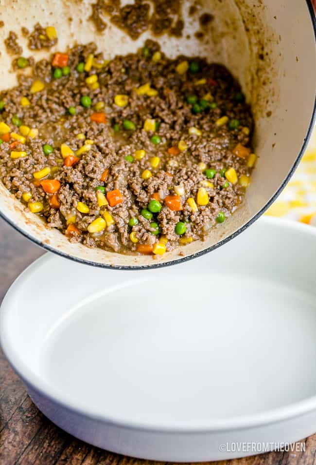 beef being poured into a casserole dish