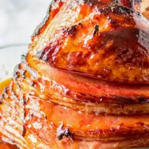 A close up photo of a spiral ham with brown sugar glaze