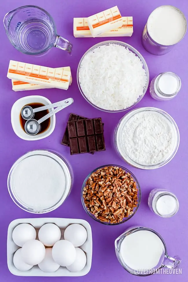 The ingredients for a bakers german chocolate cake laid out on a purple background