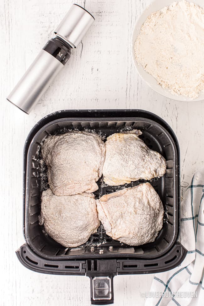 chicken thighs being cooked in an air fryer