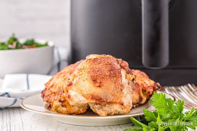 chicken thighs in front of an air fryer