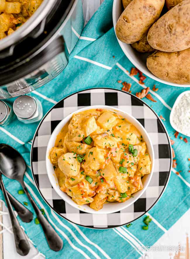 A bowl of cheesy potatoes on a blue towel