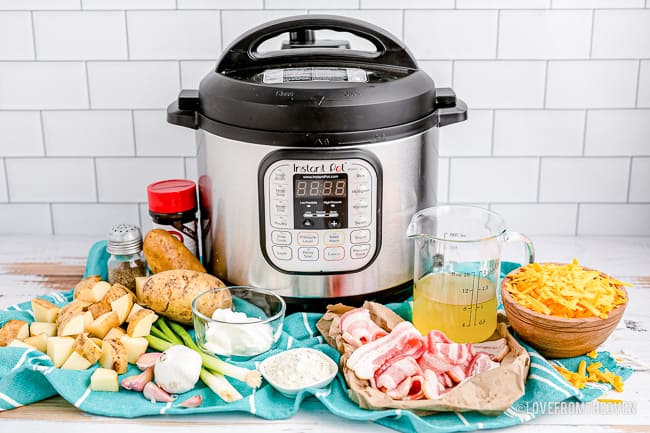 An instant pot and ingredients to make cheesy potatoes