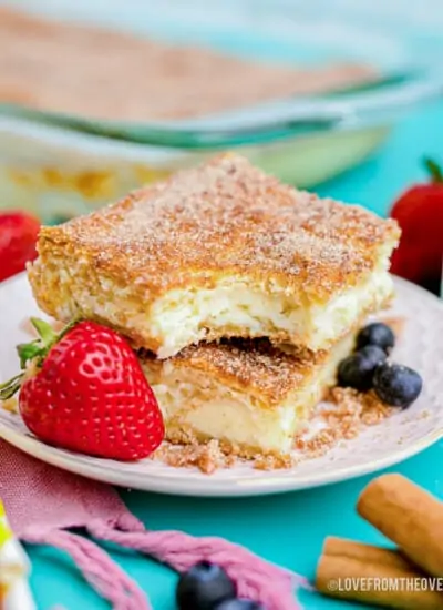 churro cheesecake on a white plate next to a strawberry