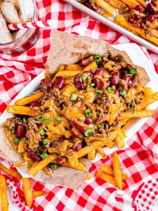 a basket of chili cheese fries on a red and white tablecloth