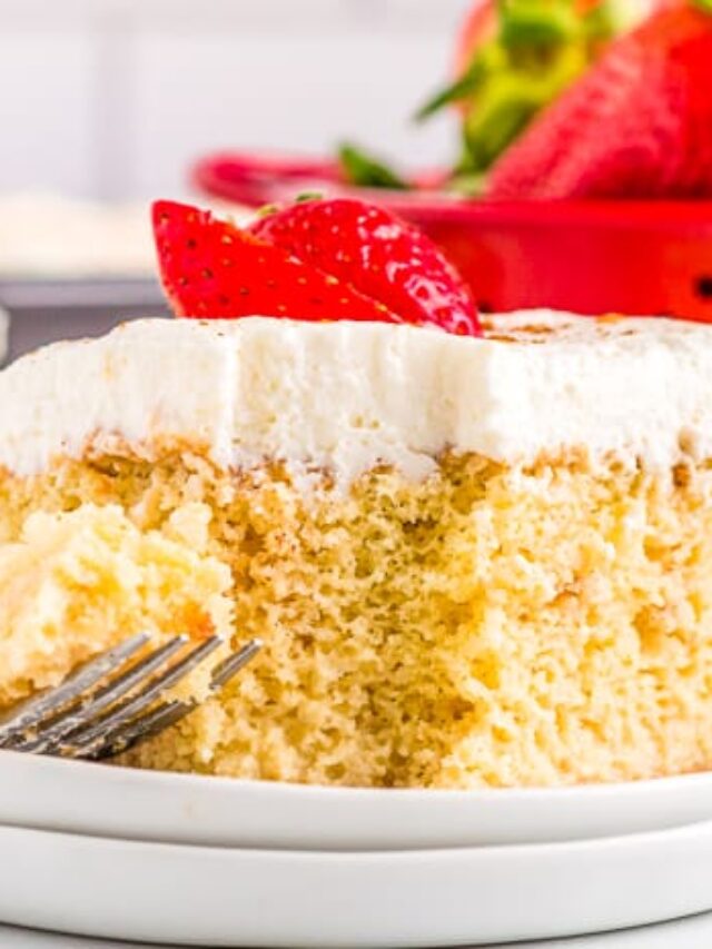a slice of tres leches cake with a red container behind it