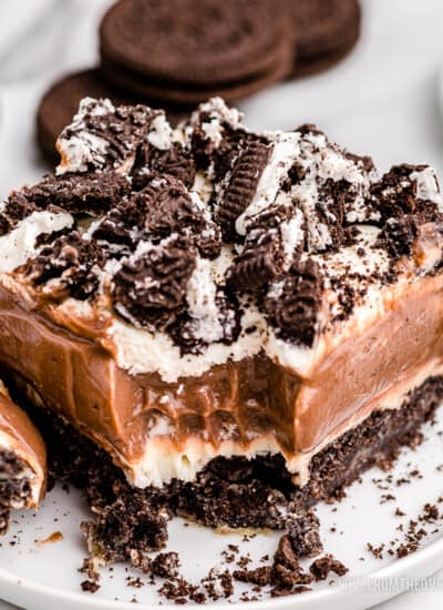 a slice of oreo dirt cake on a white plate