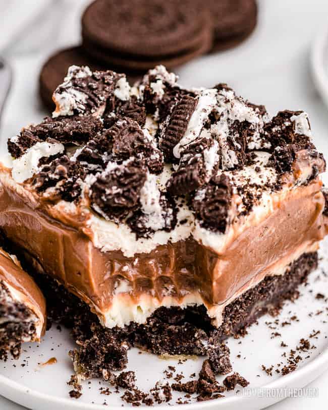 A slice of oreo dirt cake with a bite taken out