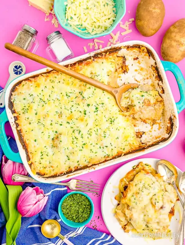 Scalloped potatoes on a pink background