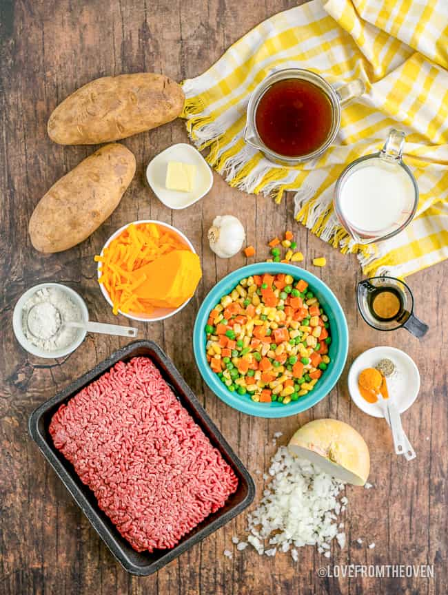 ingredients for shepards pie on a wood background