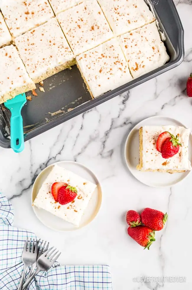 overhead shots of a tres leches cake topped with strawberries
