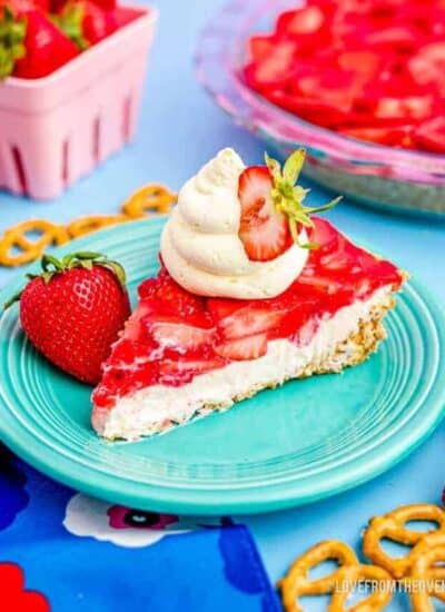 a slice of strawberry pretzel salad on a blue plate