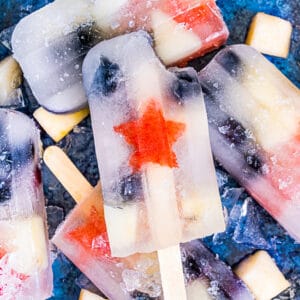 fruit popsicles on a blue background