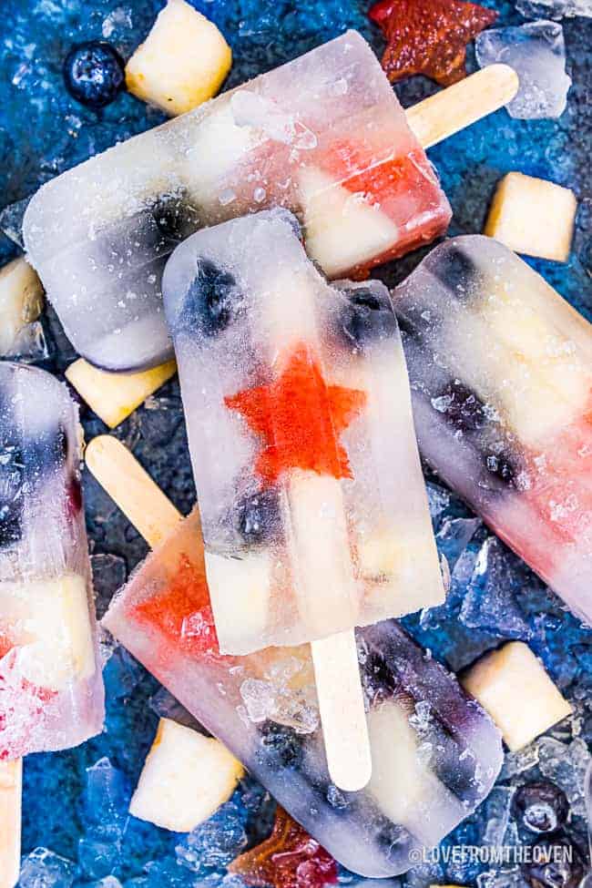 fruit popsicles on a blue background