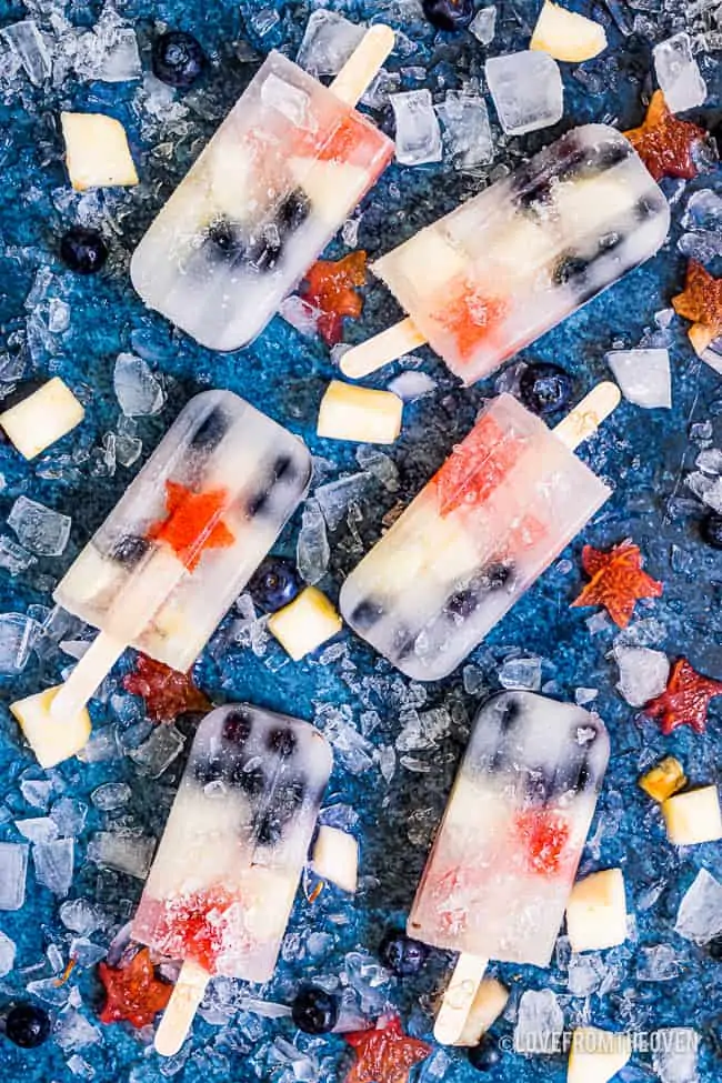 fruit popsicles on a blue background