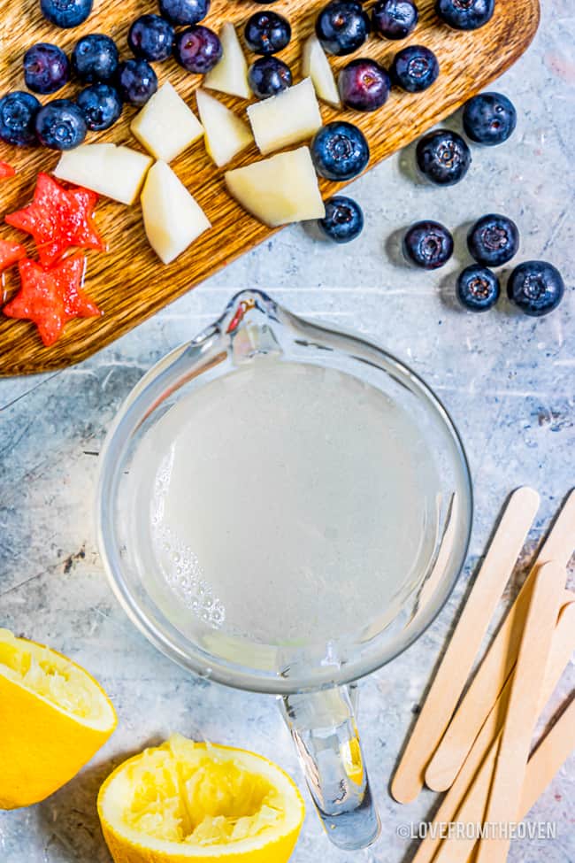 A measuring cup by fresh fruit