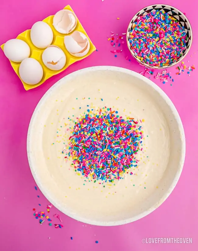 sprinkles in a bowl of cake batter