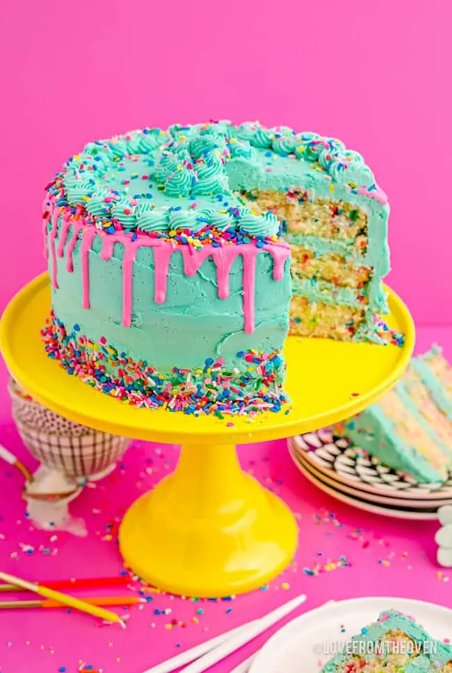a funfetti cake on a cake stand