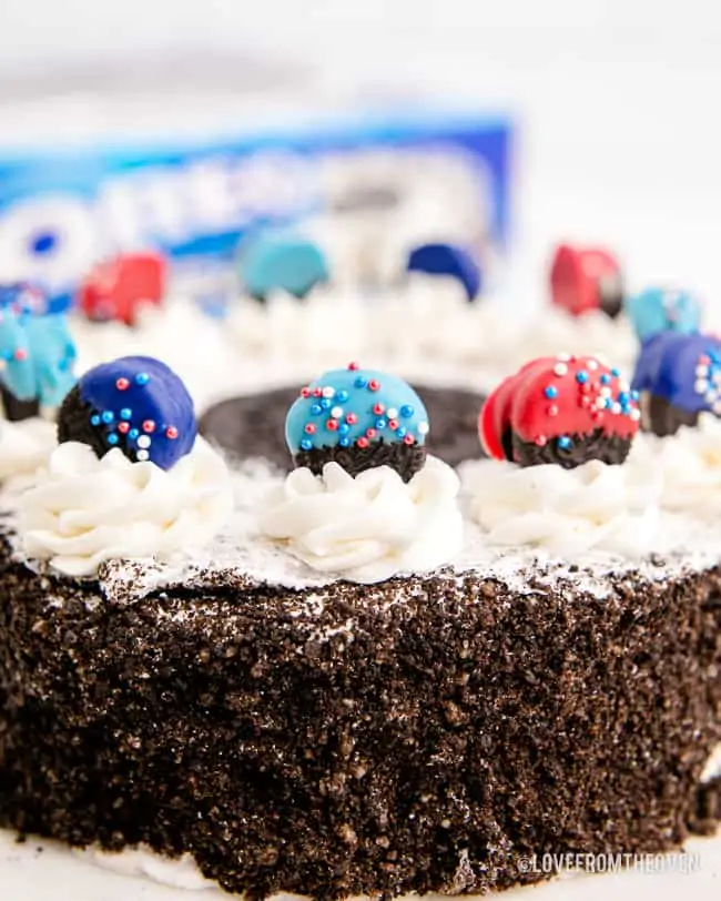 red and blue dipped oreos on a cake