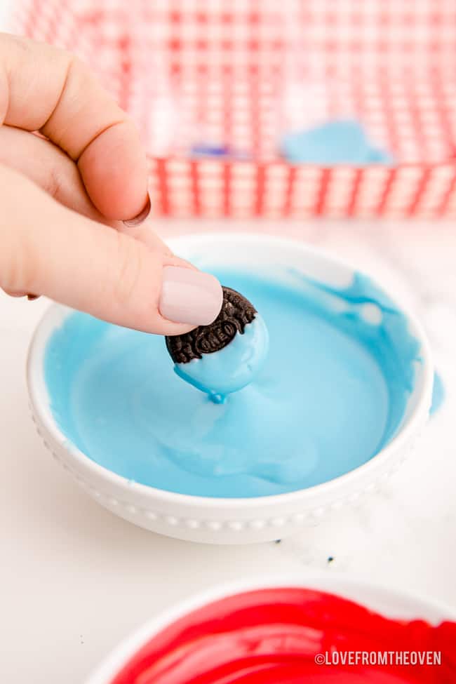 an oreo being dipped in chocolate