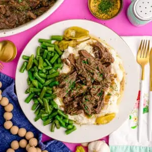 a plaste with Mississippi pot roast, potatoes and green beans