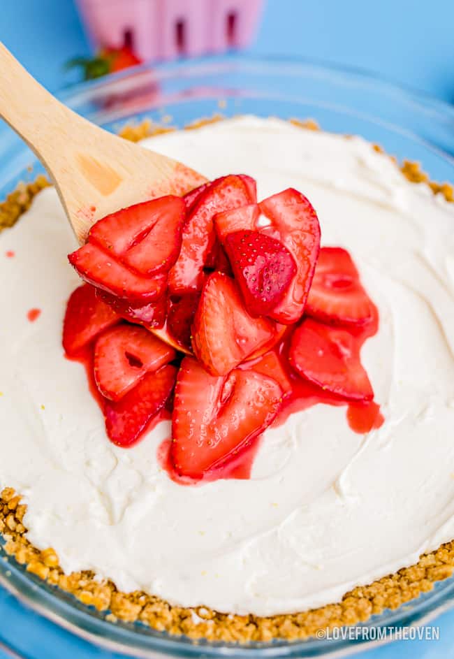 a strawberry pretzel pie being made