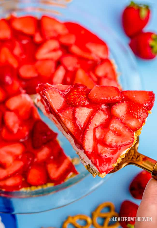 a strawberry pretzel jello pie with a slice being removed