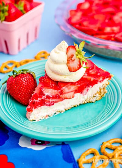 a slice of strawberry pretzel salad on a blue plate