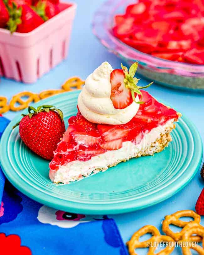 a slice of strawberry pretzel salad on a blue plate