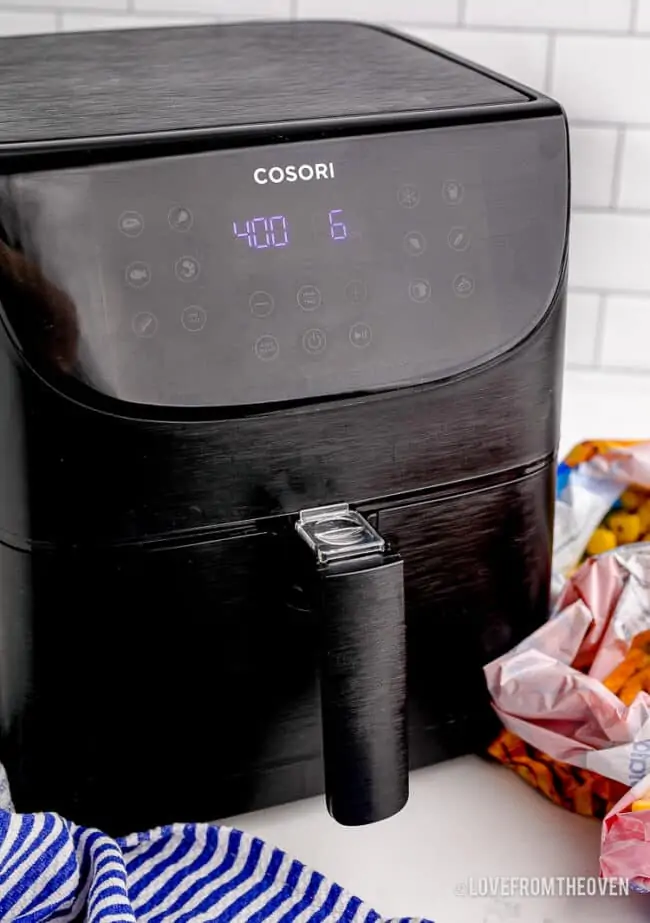 A black air fryer on a countertop.
