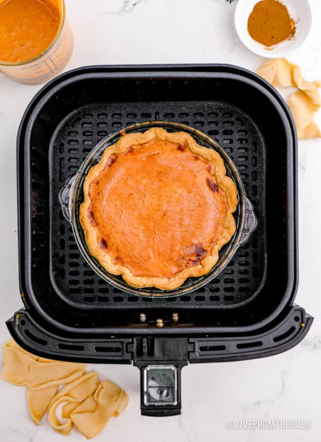 A pumpkin pie baked in an air fryer.