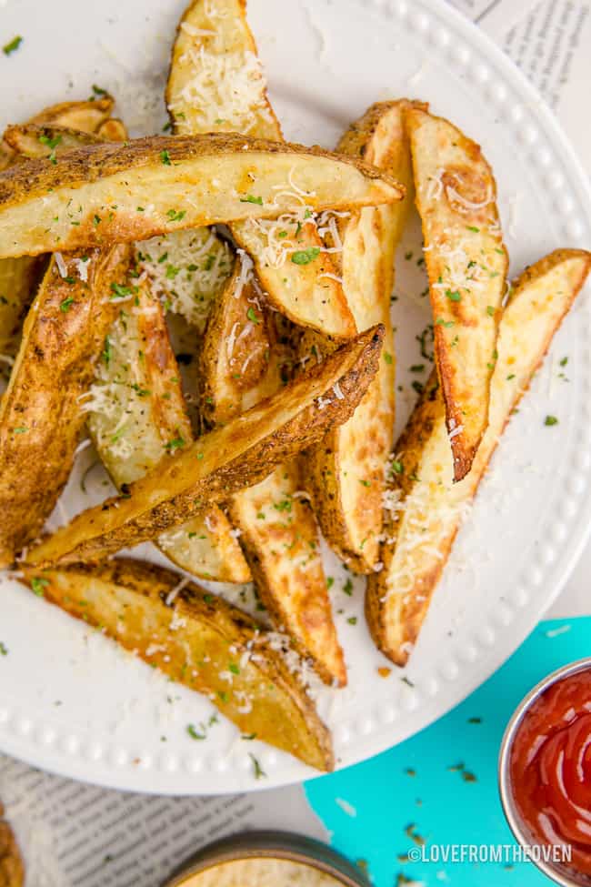 A plate full of potato wedges.