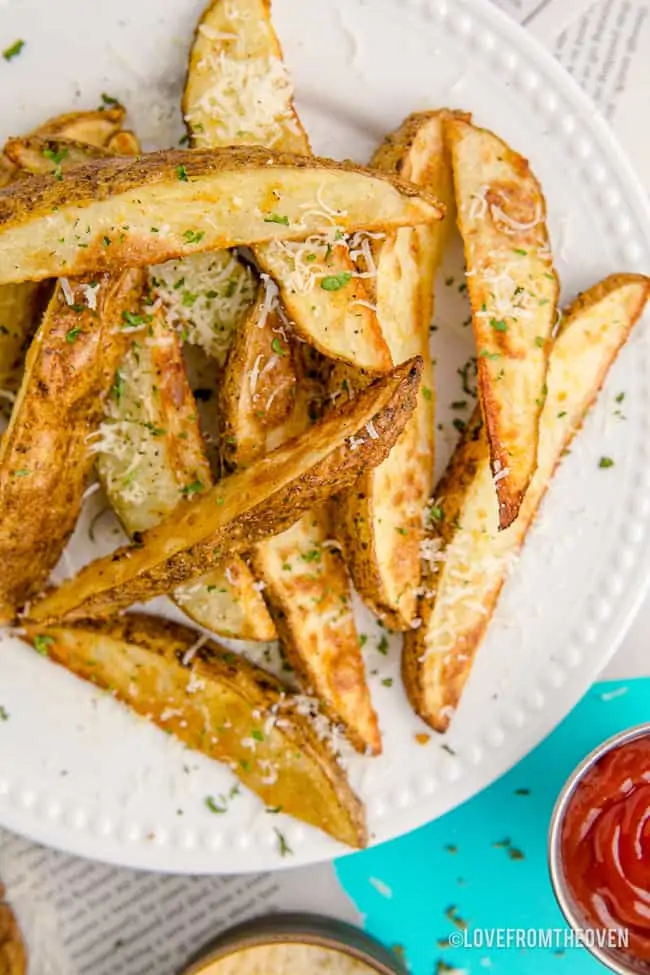 A plate full of potato wedges.