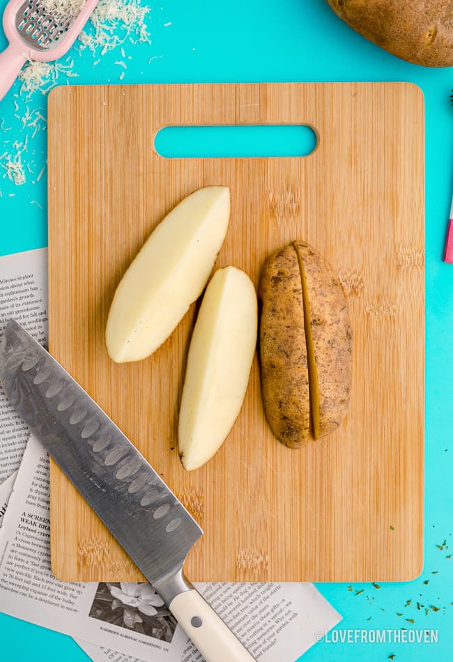 A potato being cut into wedges