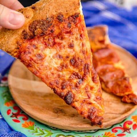 A piece of leftover pizza that has been reheated in an air fryer.